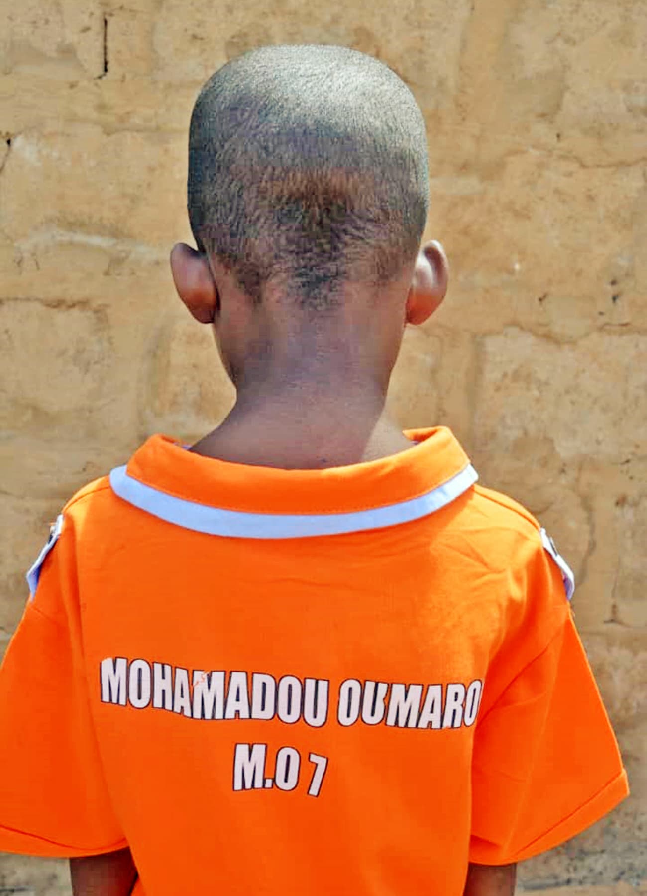 The back of the same shirt, personalized with the boy's name, showing that every child is known as an individual.
