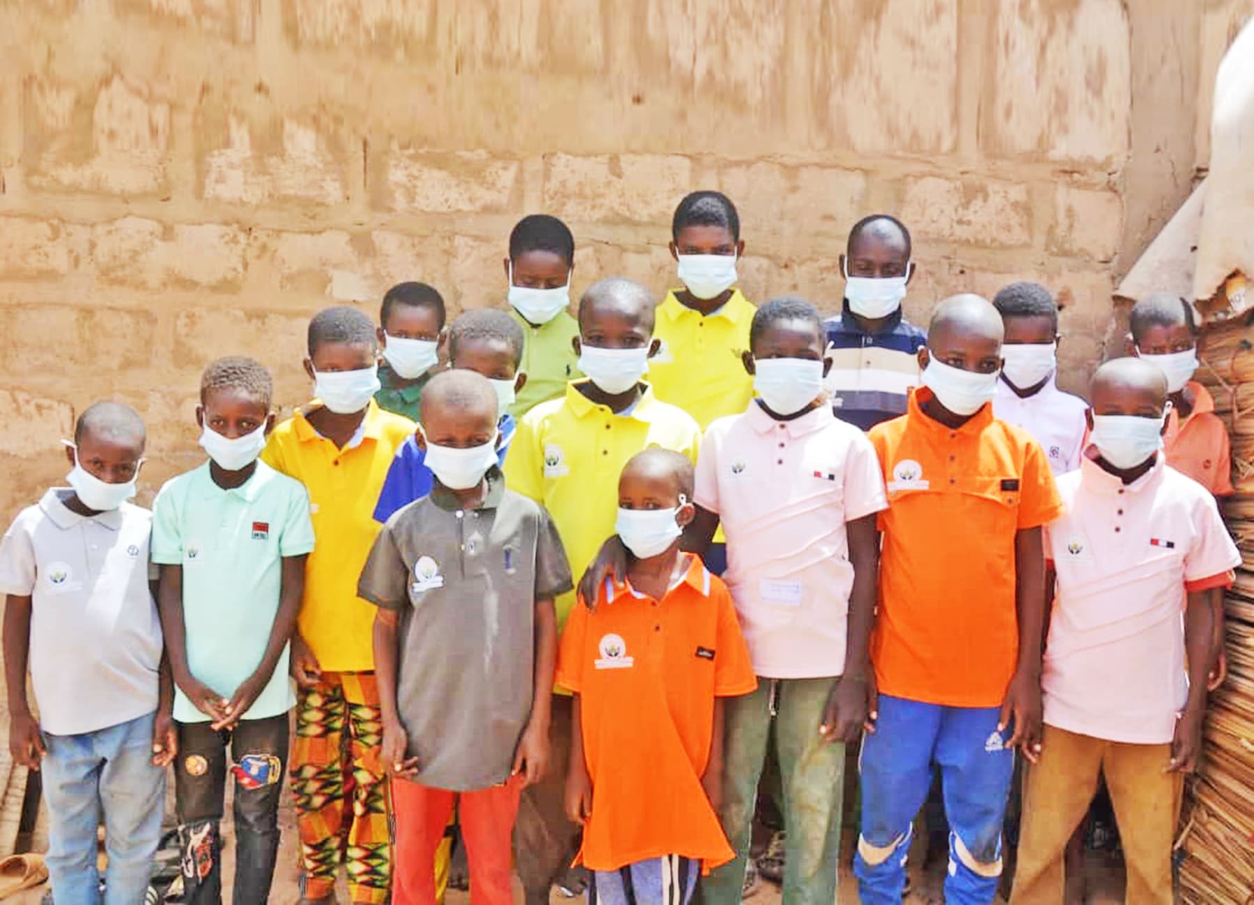 Children in Niger smiling together in their community.